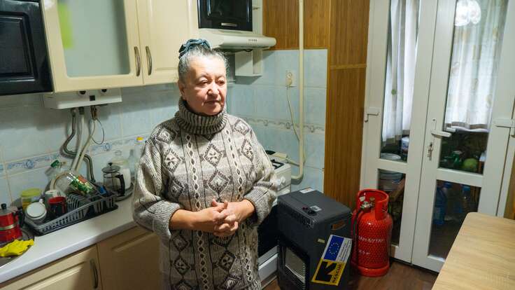 Photo of Nina standing in her kitchen